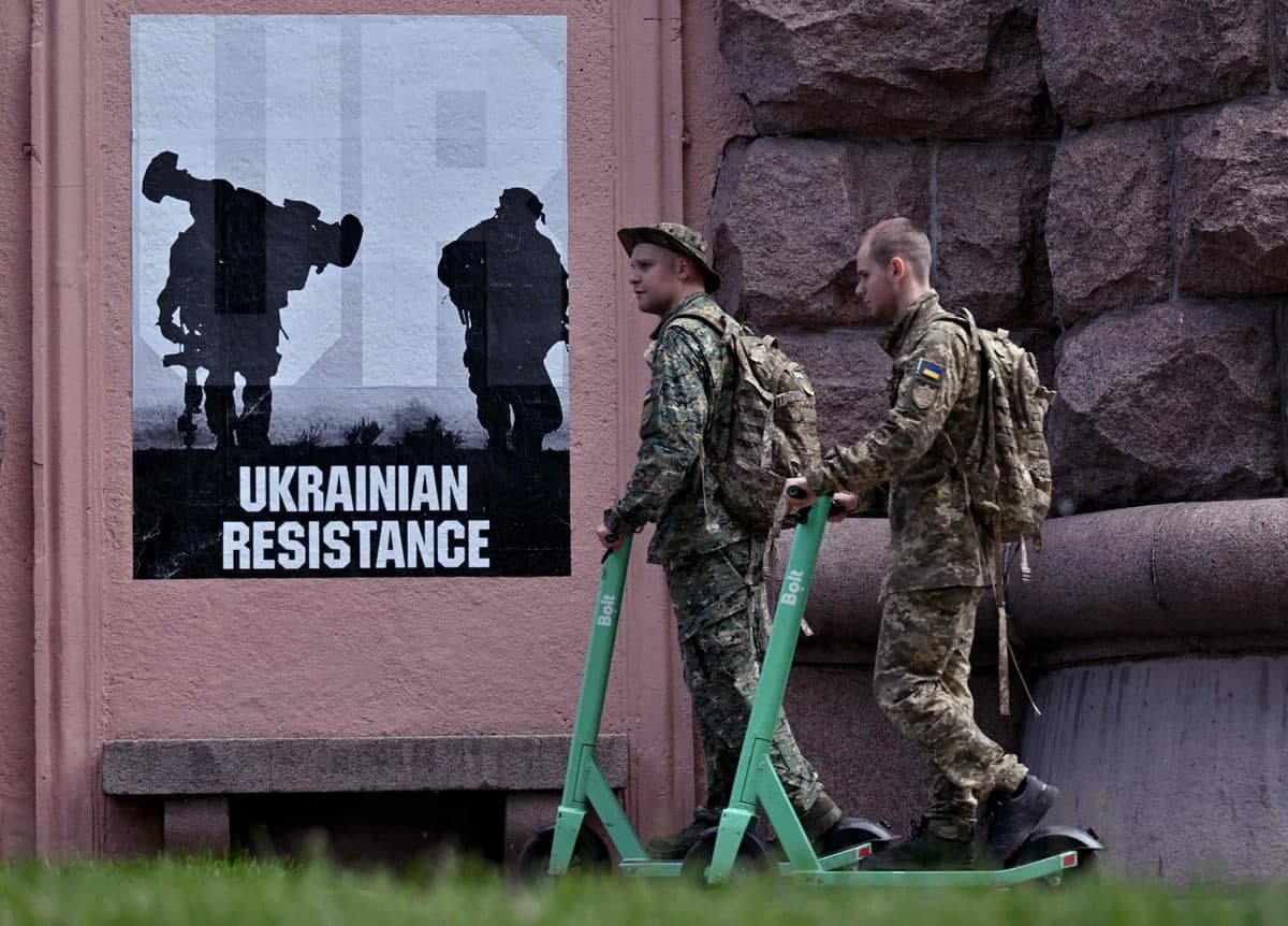 Des militaires ukrainiens conduisent des trottinettes électriques dans le centre-ville de Kyïv.
