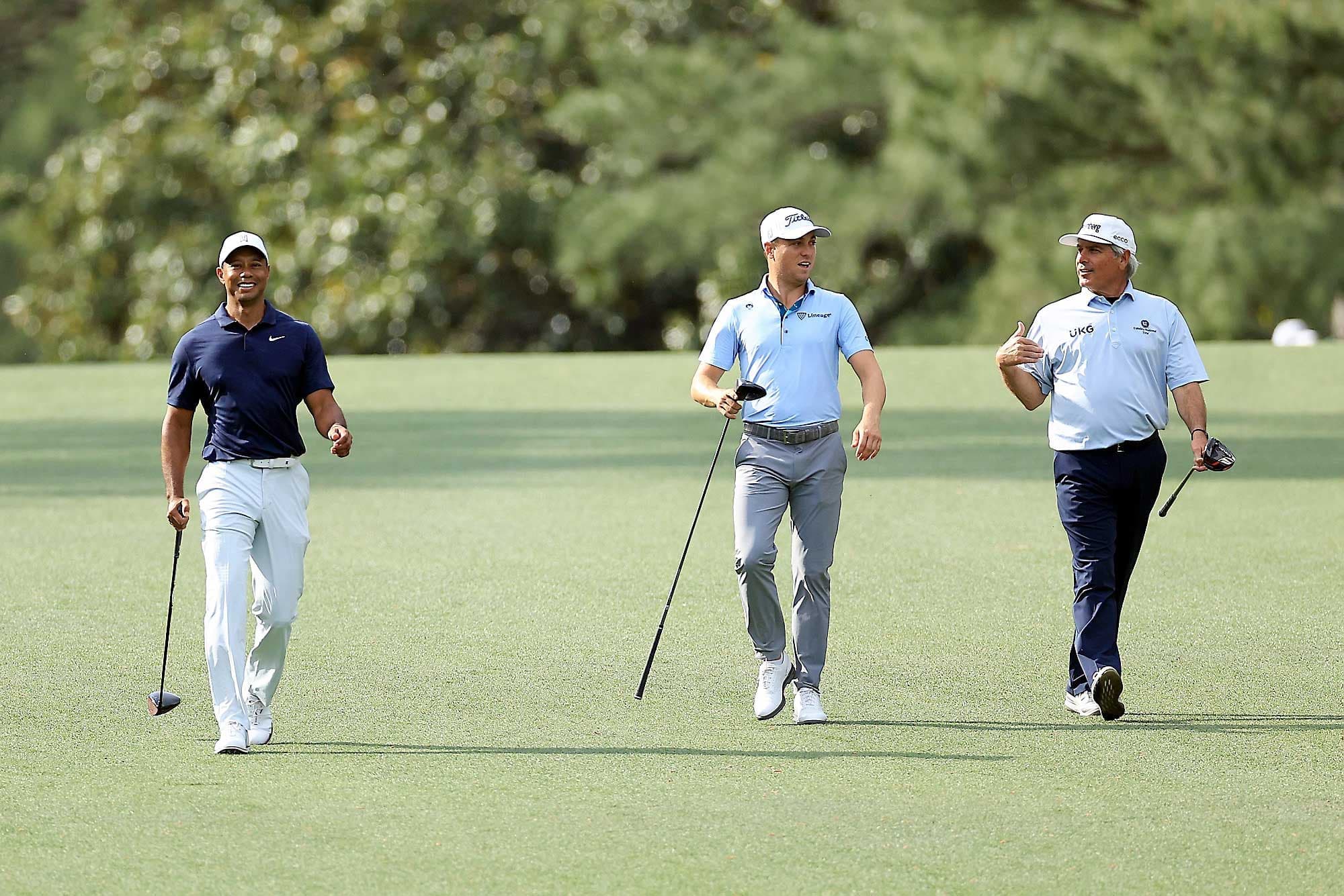 Tiger Woods (gauche), Justin Thomas (centre) et Fred Couples (droite) marchant lors de la ronde de pratique, lundi, en vue du Tournoi des Maîtres.