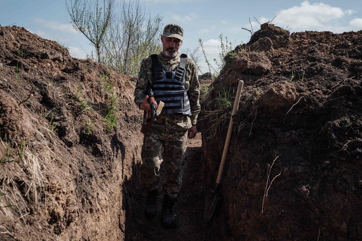 Un membre des forces ukrainiennes marche dans une tranchée près de Bavinchove, dans l'est de l'Ukraine.