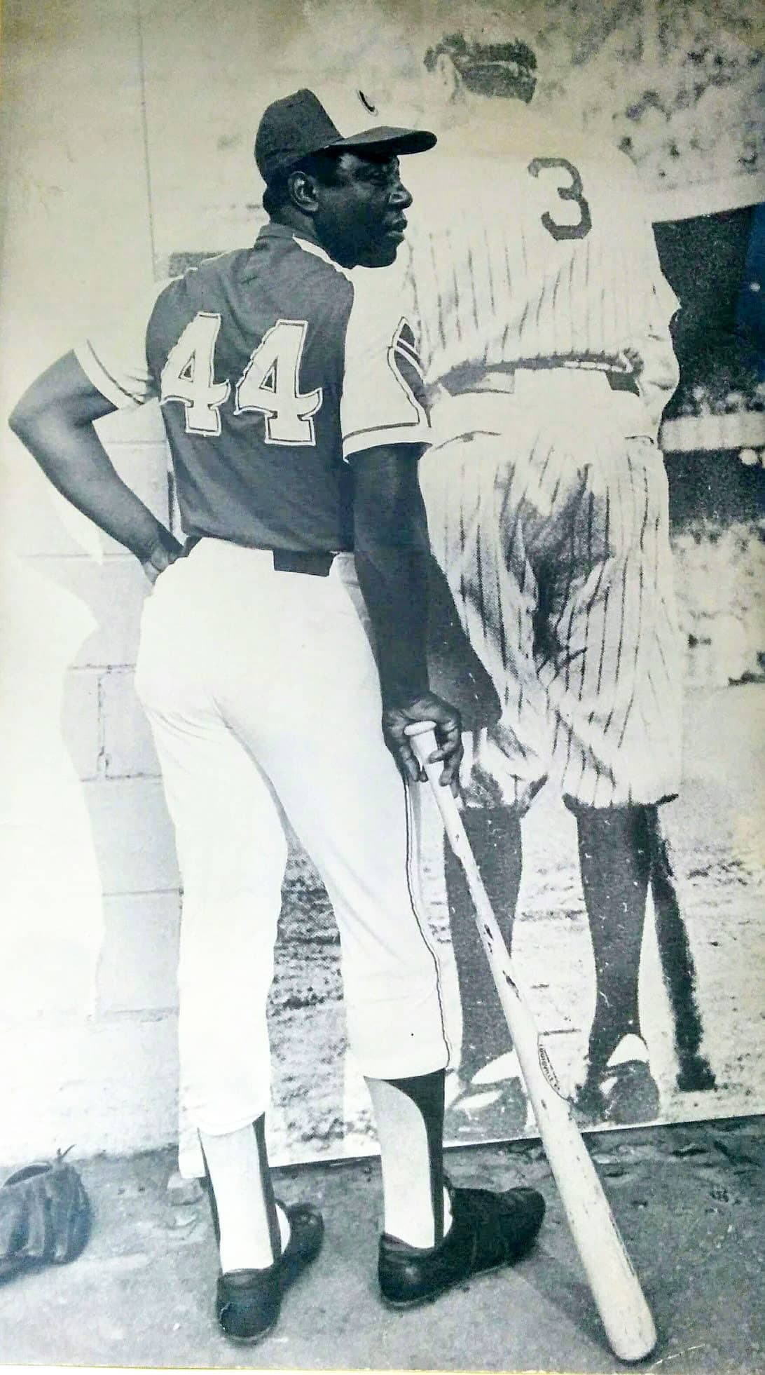 Hank Aaron devant une affiche de Babe Ruth