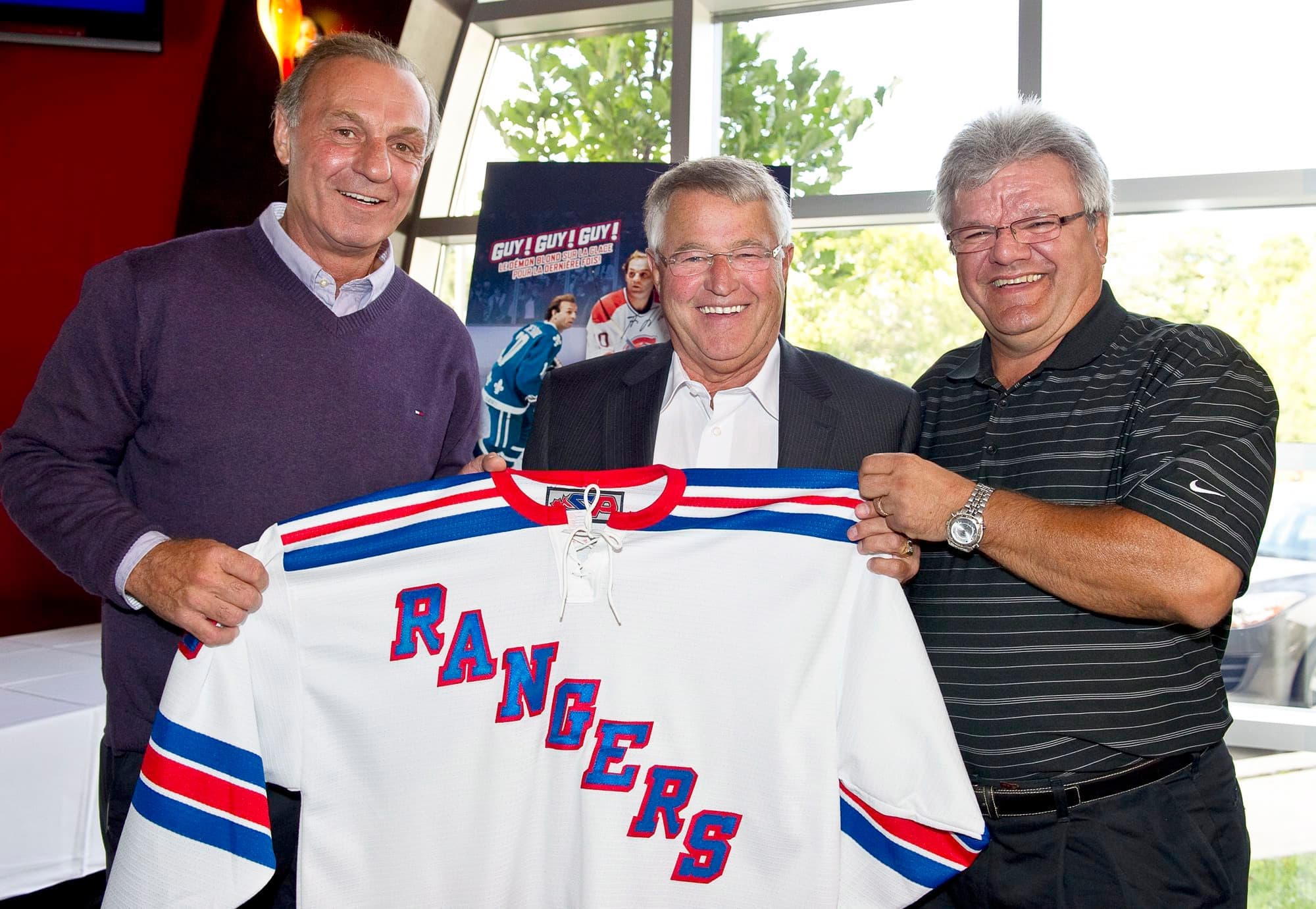 En présence de Michel Bergeron, qui tient la flanelle que les deux joueurs ont déjà portée sur Broadway.