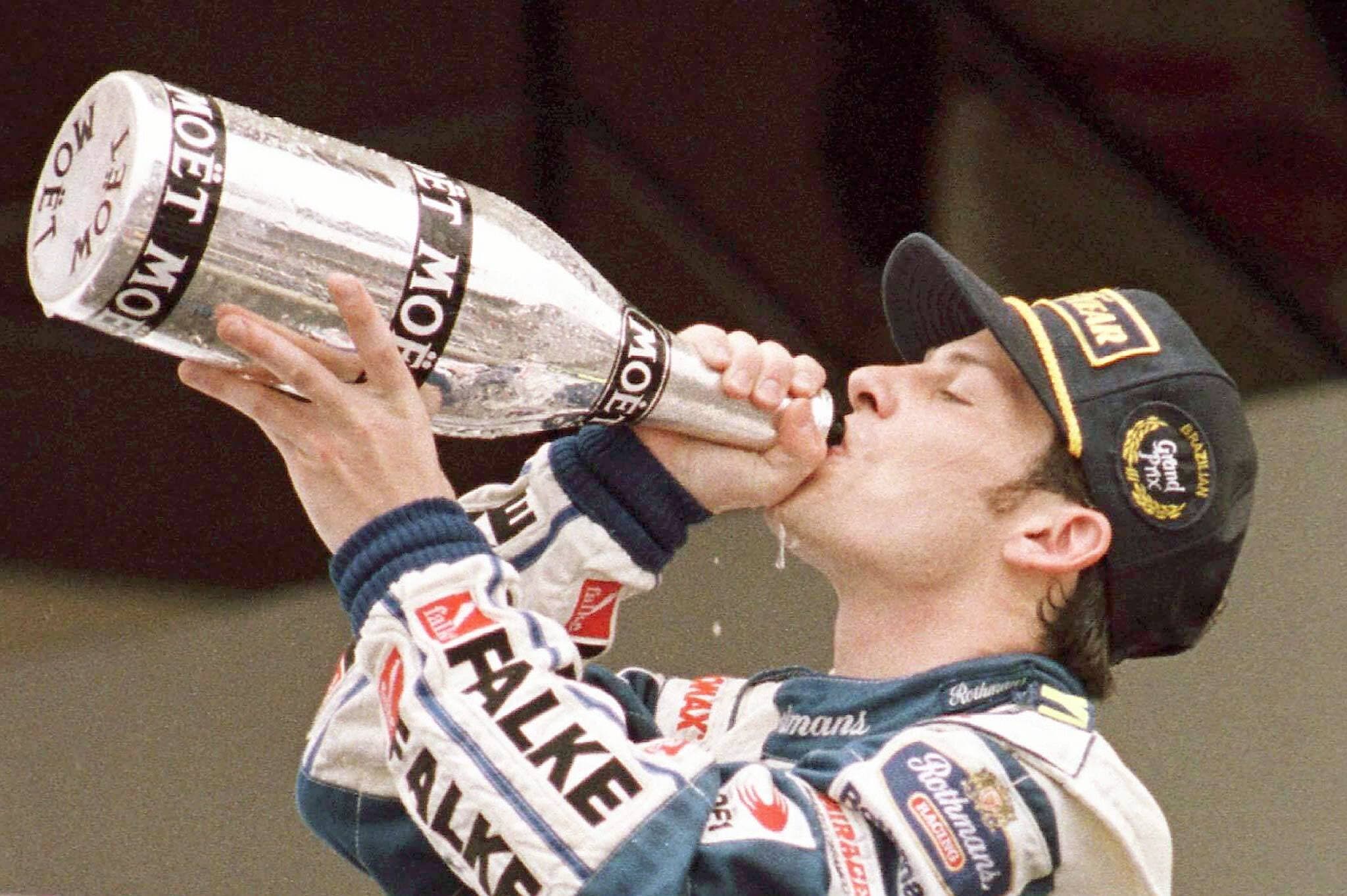 Jacques Villeneuve savourant le champagne de la victoire après son premier gain de 1997 à São Paulo au Brésil.