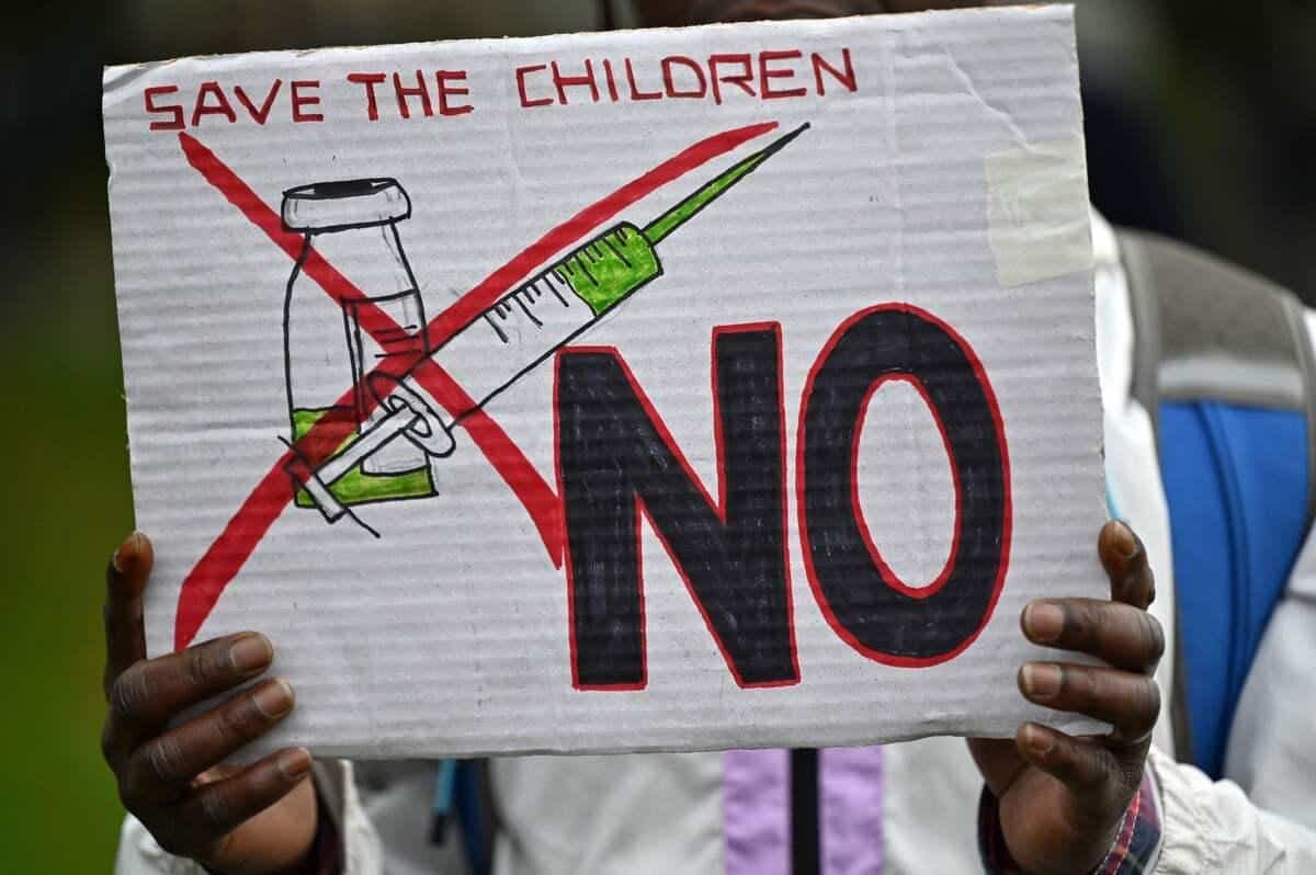 Lors d'une manifestation à Londres en octobre, une manifestation anti-vaccin tient une pancarte où il est écrit « sauver les enfants ».