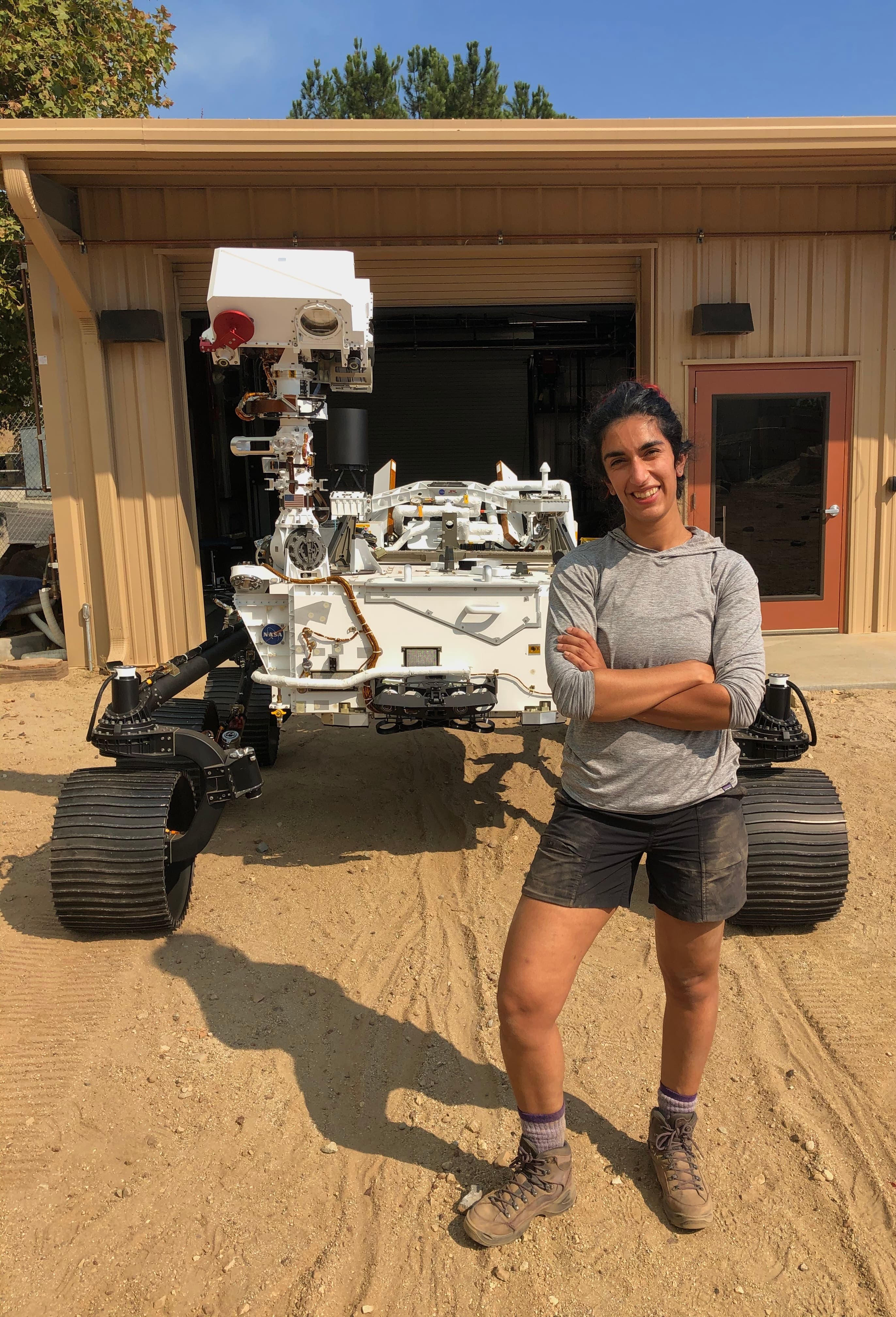 Farah Alibay pose devant le robot de la NASA Perseverance.