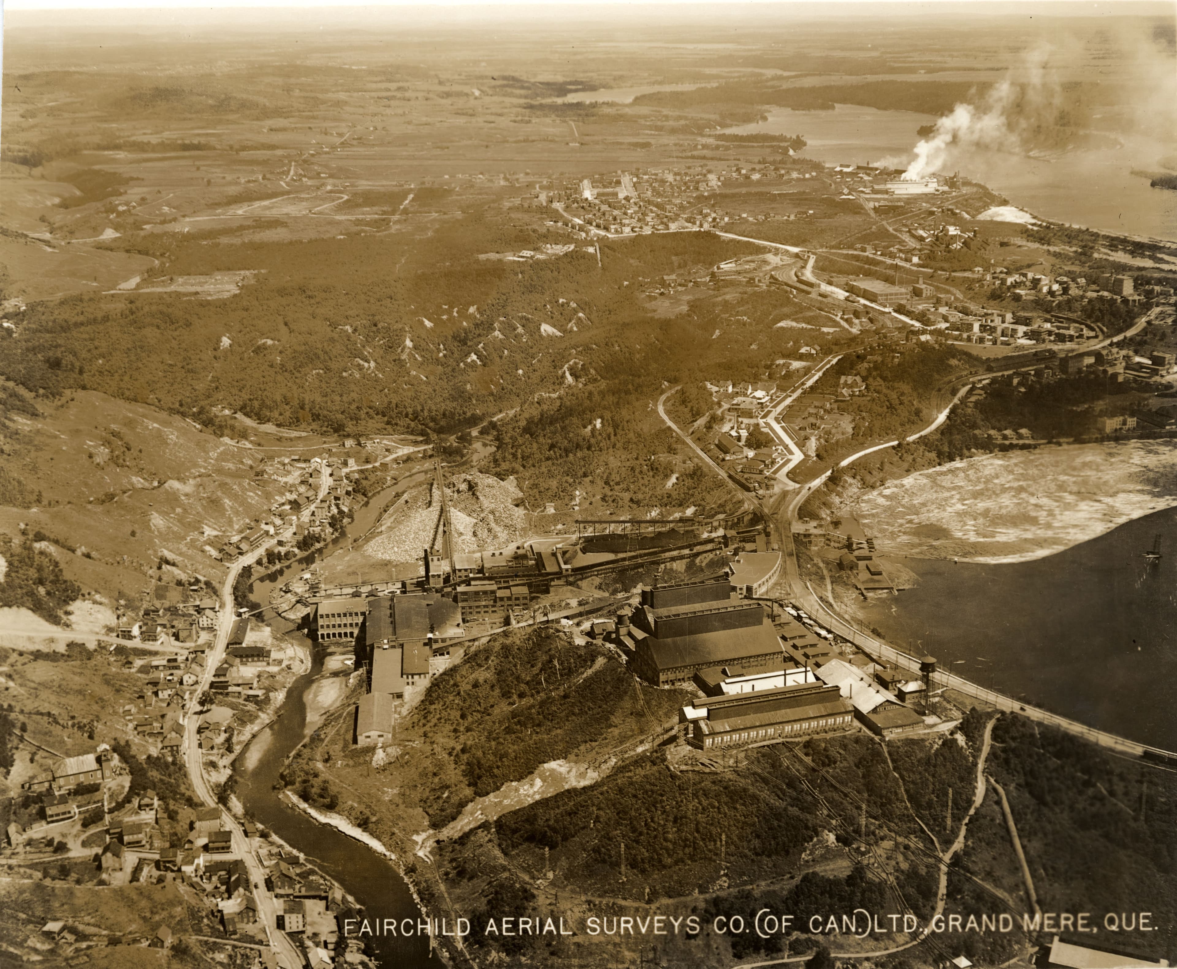 Sur cette photographie aérienne de Shawinigan, on voit une partie de la ville, l'usine Aluminium Co of Canada Ltd, la Belgo Mill et la Shawinigan Falls, 1925.